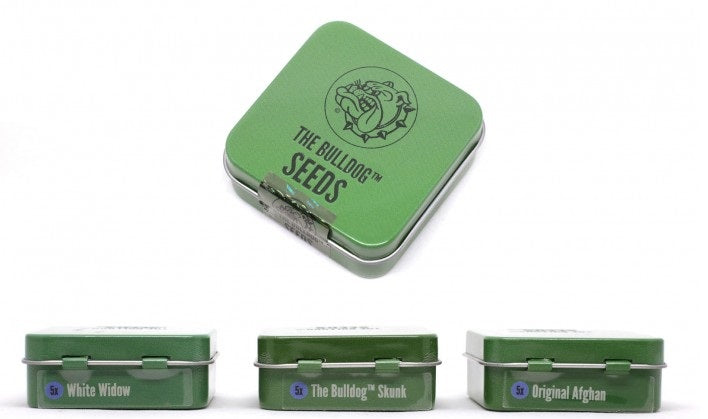 a set of four green tins with labels on them