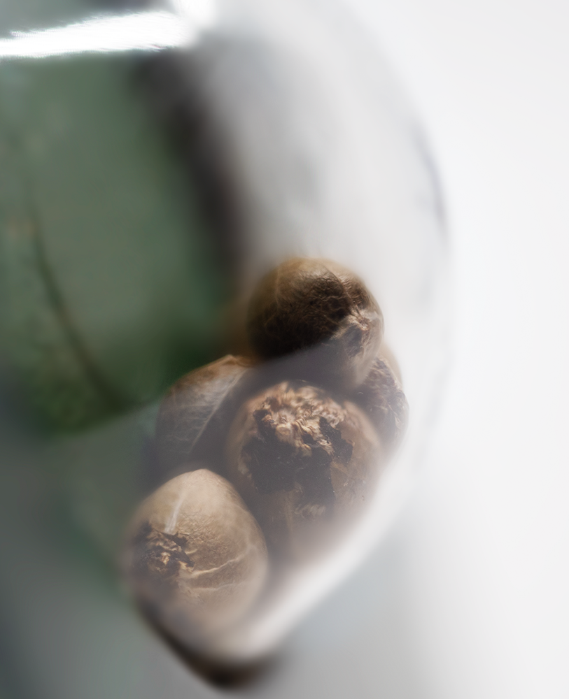 a close up of nuts in a glass container