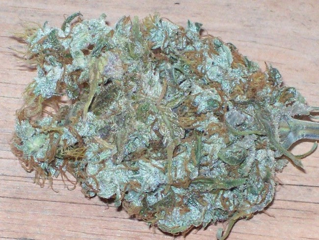 a pile of weed sitting on top of a wooden table